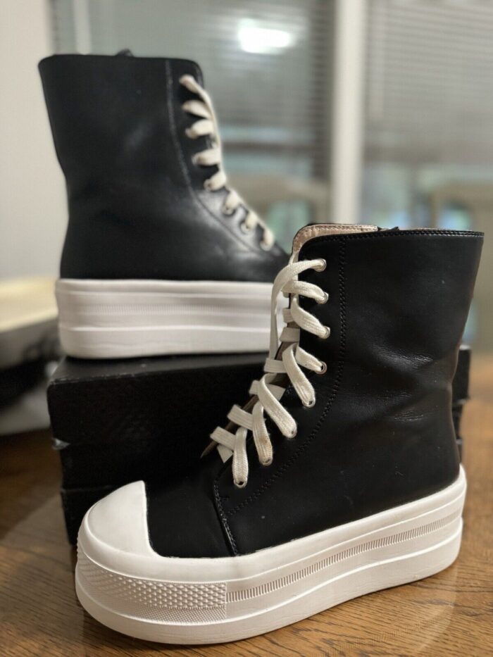 Tall, Black Platform Sneakers with White Laces. Perfect for all-weather wear. Stylish and comfortable.