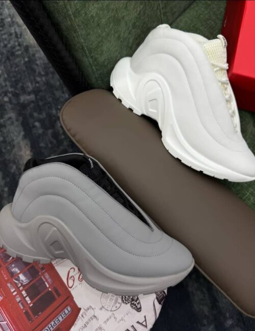 Tall, Stylish Sneakers for Nigerian Shoppers. Perfect for everyday wear, casual outings, or special events. Featuring a sleek, modern design with a mix of white and black colors. Available in various styles and sizes.