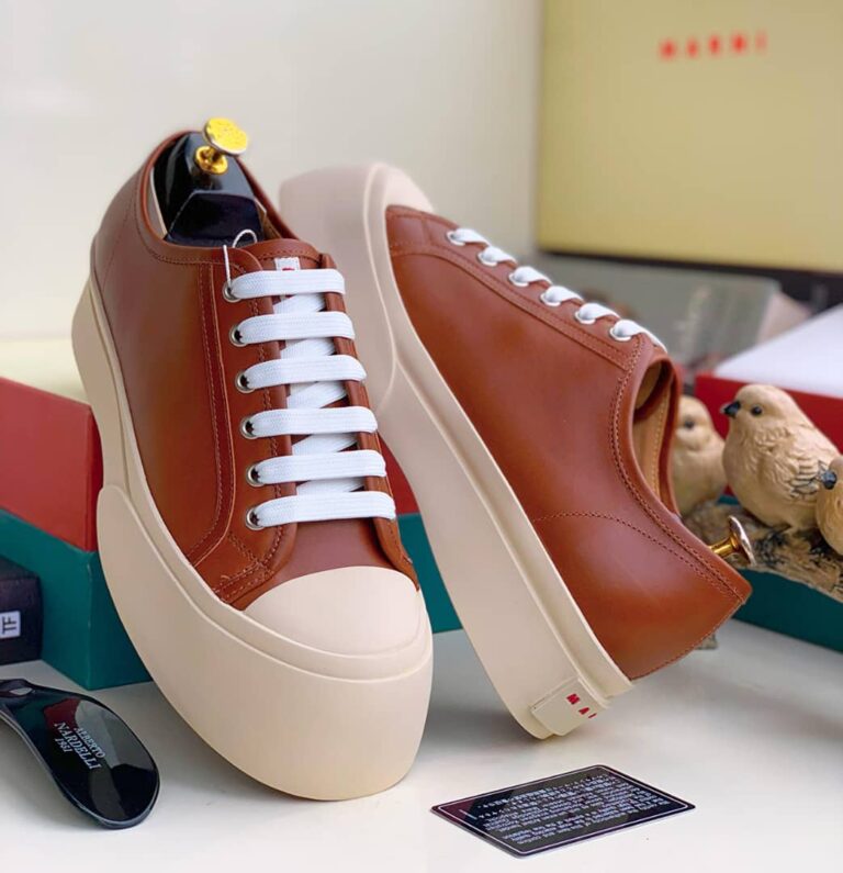 Nigerian-style platform sneakers with white laces and a beige sole, showcasing the brand's signature design. Ideal for everyday wear, these sneakers are a must-have for any Nigerian style enthusiast.