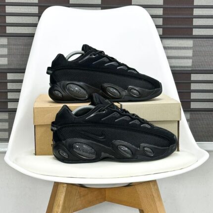 The Nike NOCTA x Glide Sneaker merges Drake’s NOCTA aesthetic with performance-driven design, featuring a sleek, futuristic silhouette, responsive cushioning, and collaborative branding for street-ready versatility.