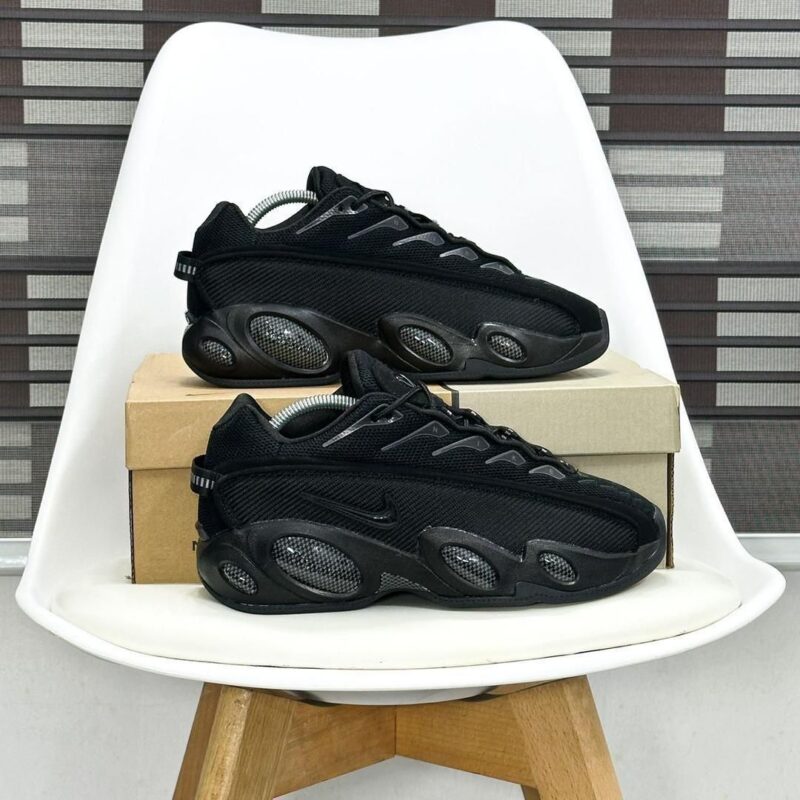 The Nike NOCTA x Glide Sneaker merges Drake’s NOCTA aesthetic with performance-driven design, featuring a sleek, futuristic silhouette, responsive cushioning, and collaborative branding for street-ready versatility.