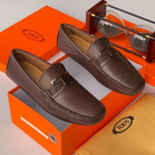 Tod's iconic Gommino loafers in rich brown leather, featuring the signature pebble sole for timeless comfort and Italian elegance.