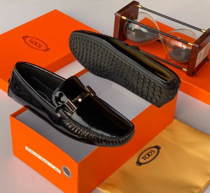The Tod's Black Espadrille Loafer merges Italian craftsmanship with effortless style, featuring a sleek silhouette and signature espadrille-inspired sole for laid-back sophistication.