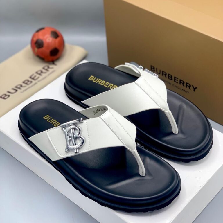 Burberry sandals on display, showcasing the brand's signature logo and design. The image also includes a small soccer ball and a Burberry branded bag.